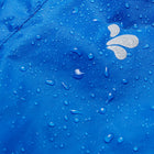 Close-up of Originals Waterproof Trousers Blue fabric, covered in water droplets, showing waterproof nature of the material and logo.
